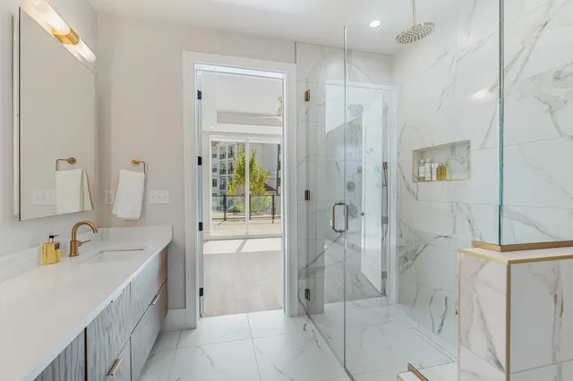 a bathroom with a sink a toilet and shower