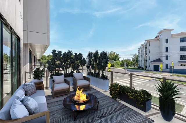a view of a patio with couches and potted plants