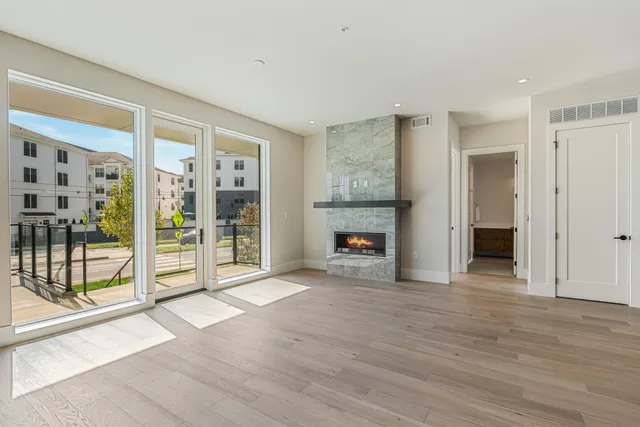 a view of an empty room with glass door and balcony