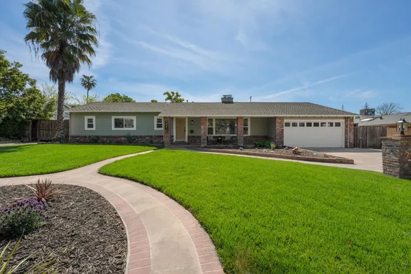 a front view of a house with garden