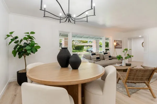 a living room with furniture potted plant and a chandelier
