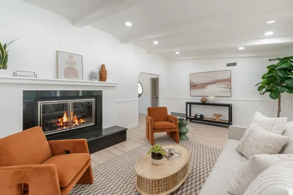 a living room with furniture and a fireplace