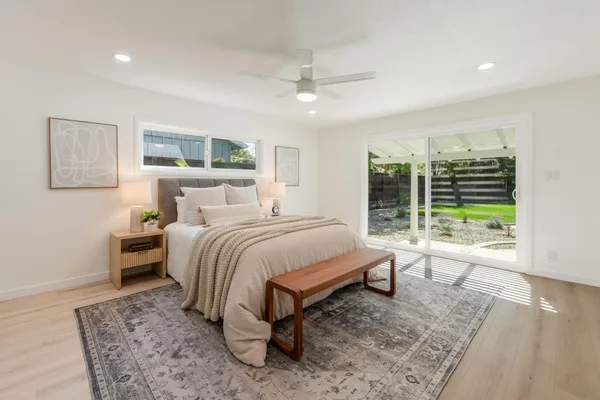 a bedroom with a bed and glass window