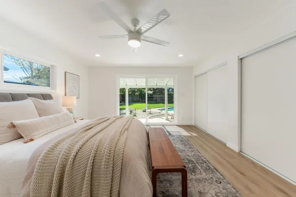 a spacious bedroom with a large bed and a large window