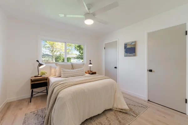 a bedroom with bed and a chandelier