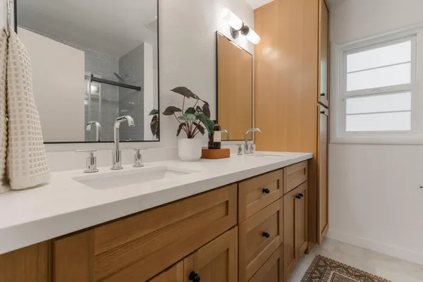 a bathroom with a double vanity sink and a mirror