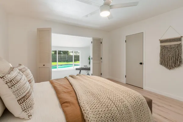 a bedroom with a large bed and a window