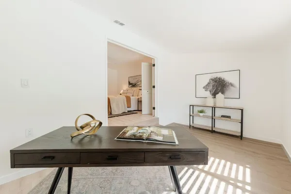 a living room with furniture and wooden floor
