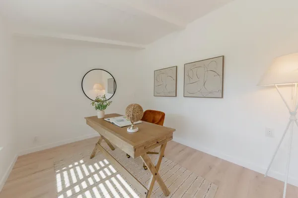 a workspace with furniture and mirror