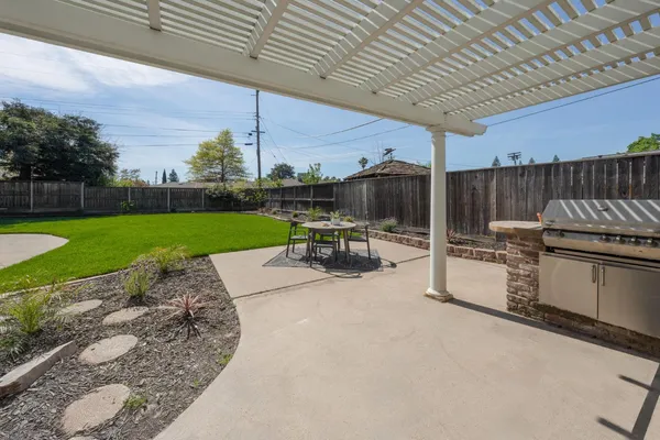 a view of a backyard with sitting area