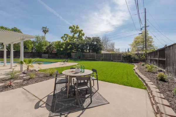 a view of a backyard with sitting area
