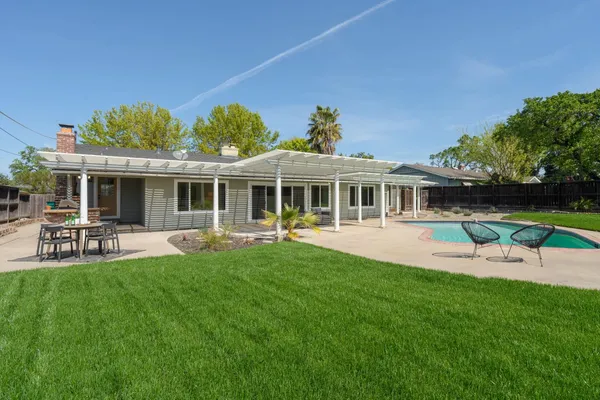 a view of a house with a backyard porch and sitting area