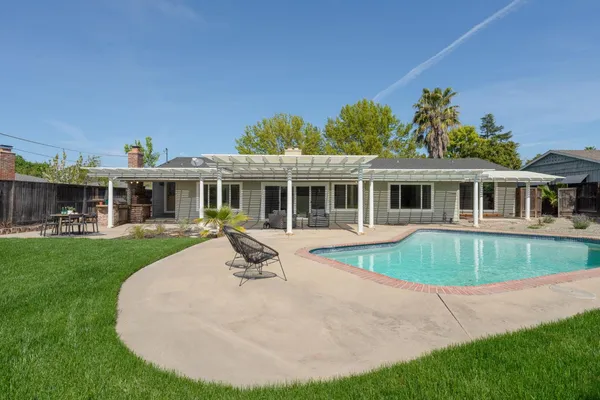 a front view of a house with a garden and plants