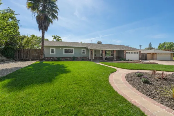 a view of a house with a swimming pool and a yard