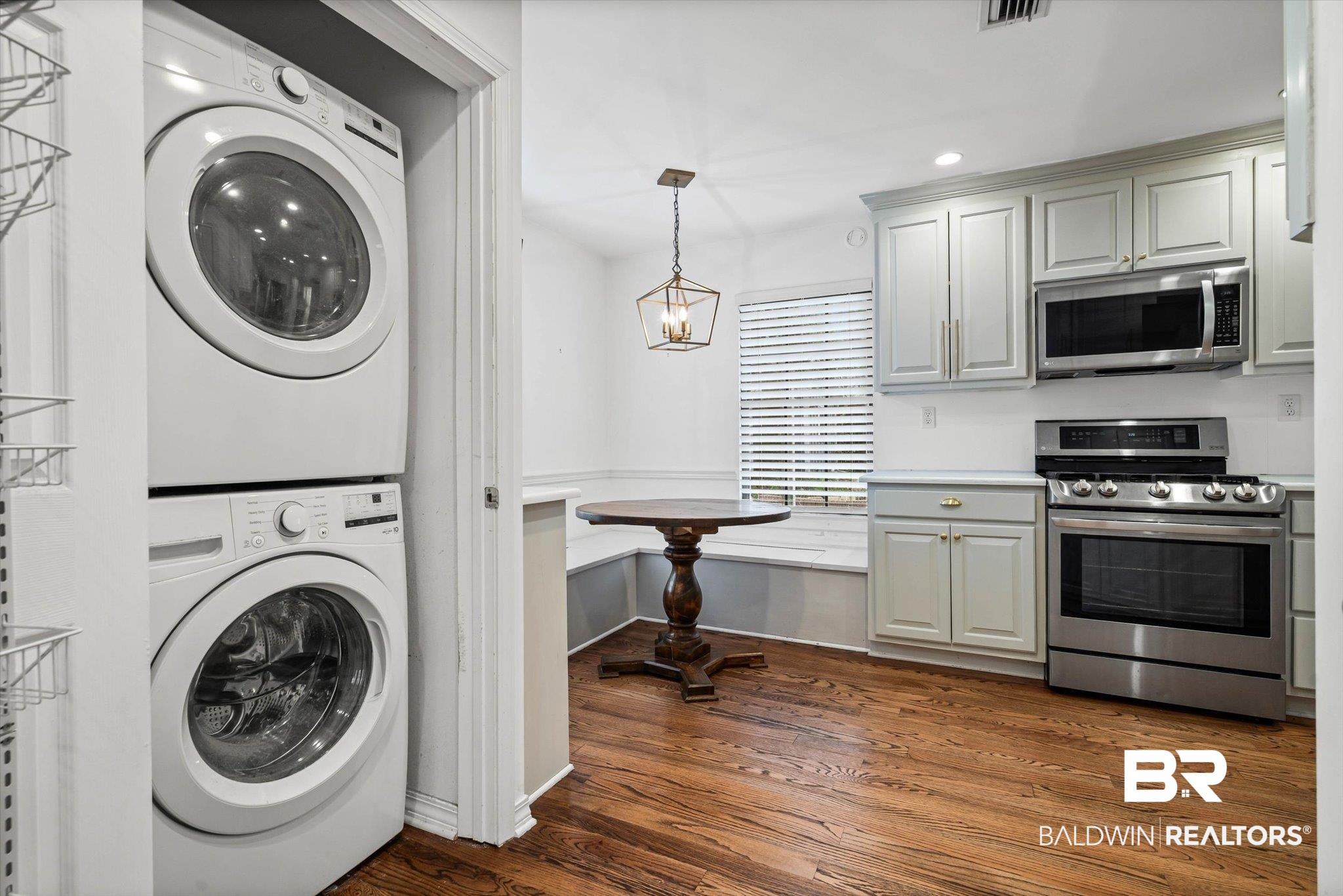 11 York Place Mobile, AL 36608 - Photo 17 of 24 Washroom with stacked washer and clothes dryer, dark wood-style floors, recessed lighting, and a chandelier
