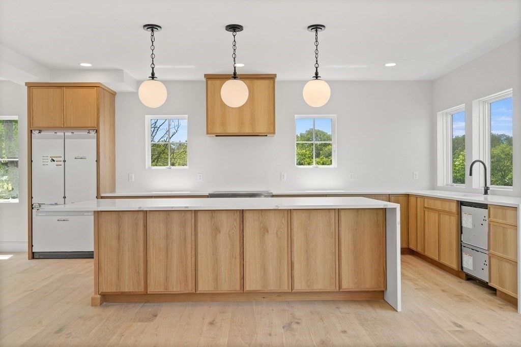 10 Chestnut Place Hingham, MA 02043 - Photo 18 of 41 a large kitchen with a large window and wooden floor