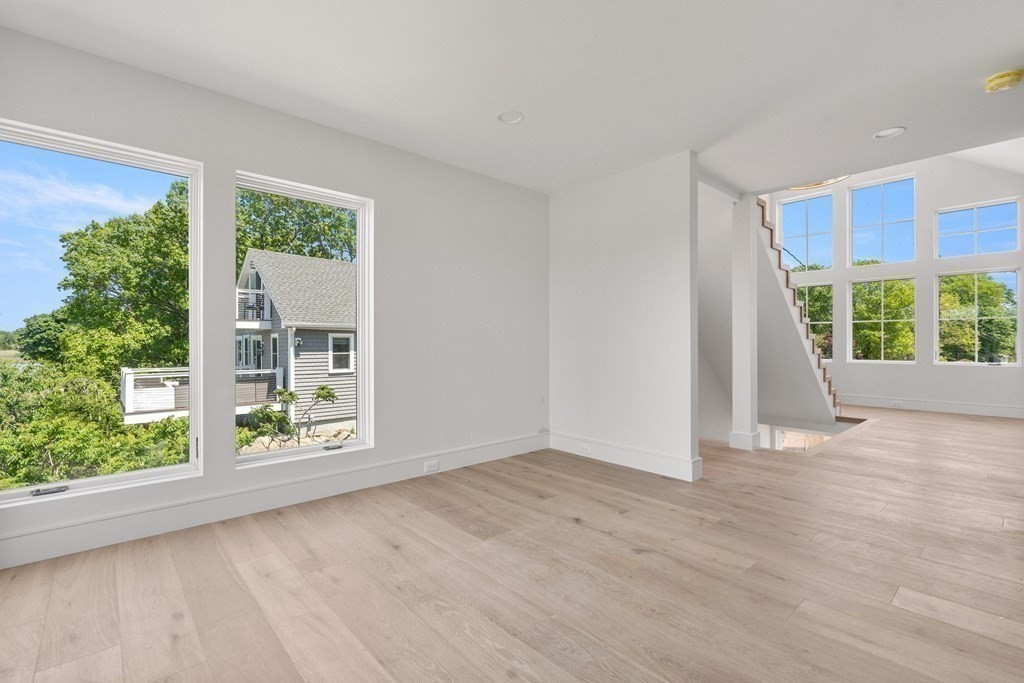 10 Chestnut Place Hingham, MA 02043 - Photo 23 of 41 an empty room with wooden floor and windows