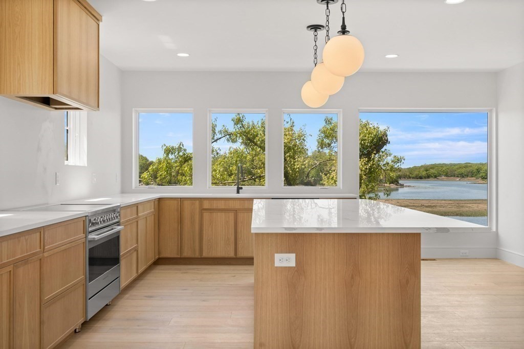 10 Chestnut Place Hingham, MA 02043 - Photo 5 of 41 a kitchen with stainless steel appliances granite countertop a stove a sink and a large window