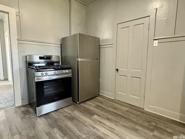 a kitchen with a stove and a refrigerator