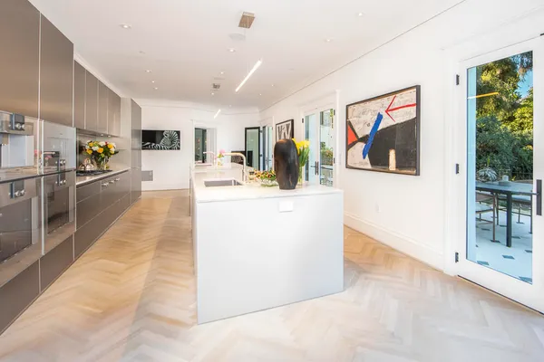 a view living room with stainless steel appliances kitchen island granite countertop furniture and a kitchen view