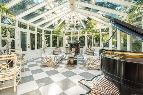 a view of a patio with couches table and chairs with wooden floor