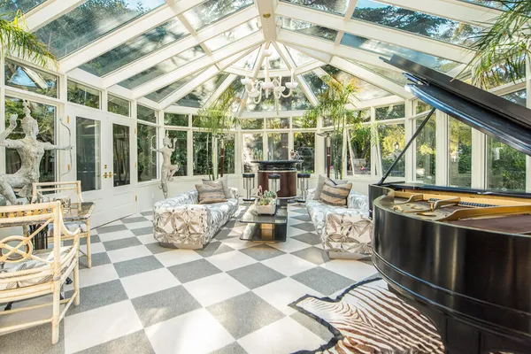 a view of a patio with couches table and chairs with wooden floor