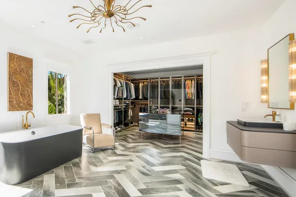 a living room with furniture a chandelier and a dining table