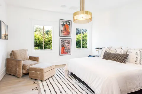 a bedroom with a bed and a couch