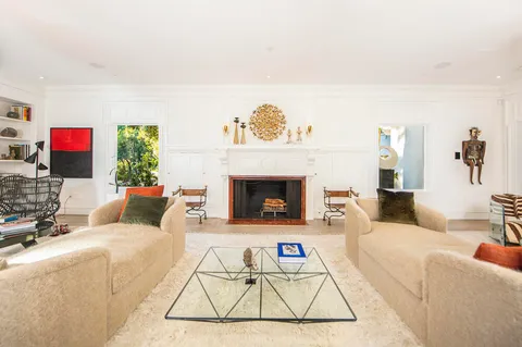 a living room with furniture a rug and a fireplace