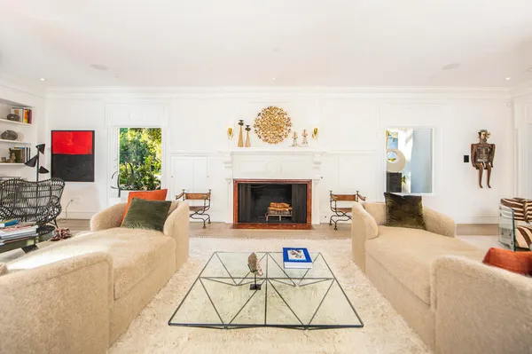 a living room with furniture a rug and a fireplace