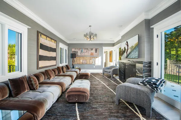 a spacious bedroom with a balcony a bed couch and a large window