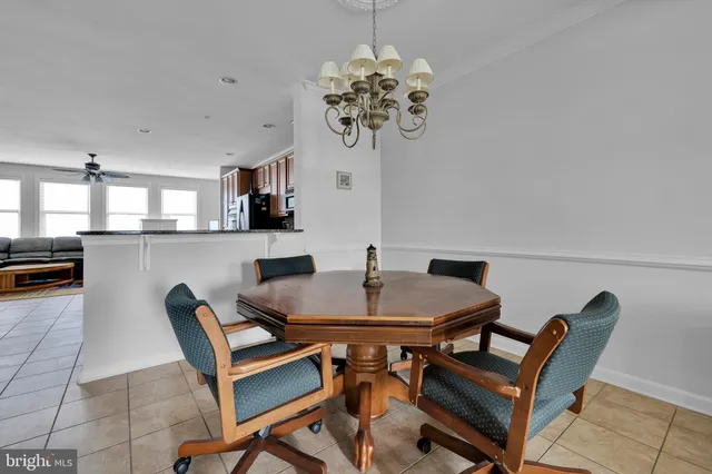 a view of a dining room with furniture and chandelier