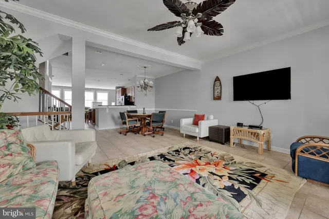 a bedroom with furniture a rug toys and a flat screen tv