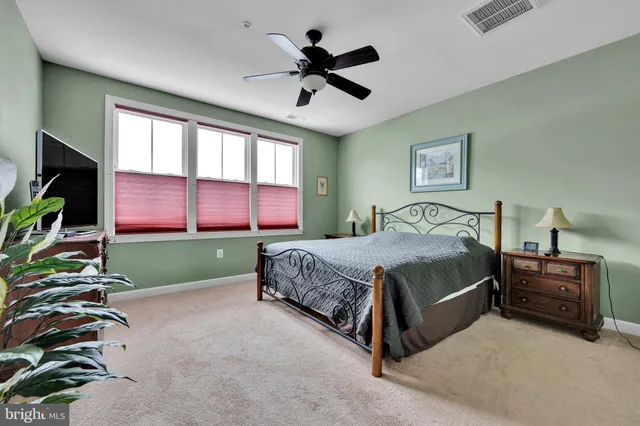 a spacious bedroom with a bed and a chandelier