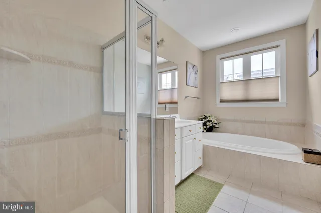 a spacious bathroom with a bathtub and shower