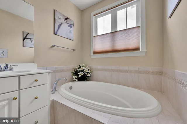 a bathroom with a bathtub and sink