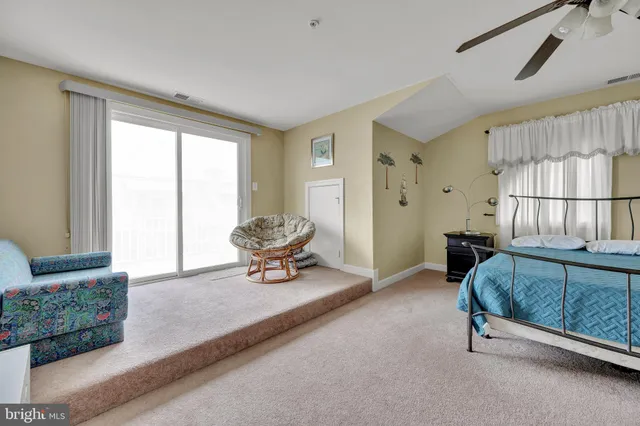 a room with a bed and a dresser