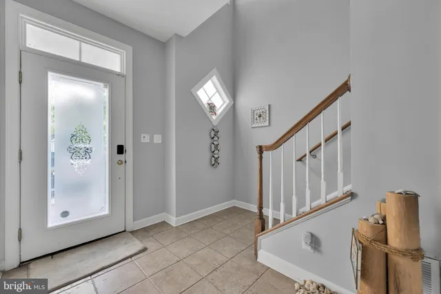a bedroom with a large bed and wooden floor