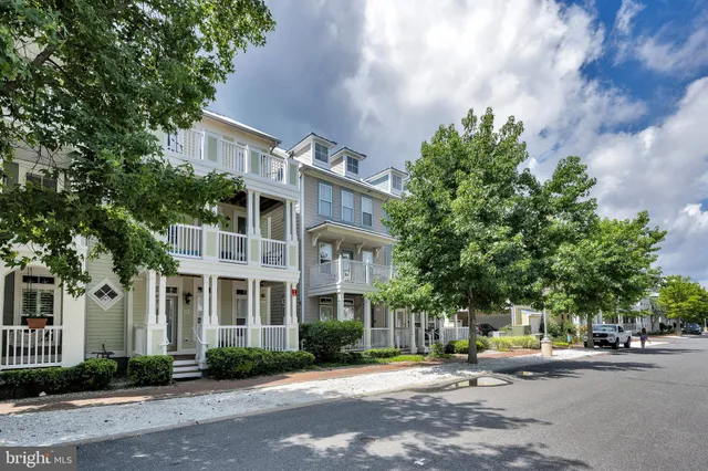 a front view of a building with street view and car parked