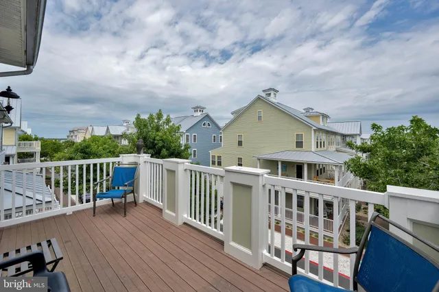 a view of a chairs and table in the balcony
