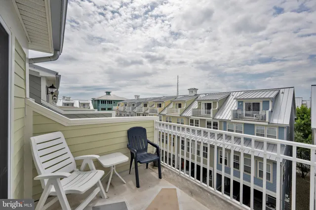 a view of a balcony with table and chairs