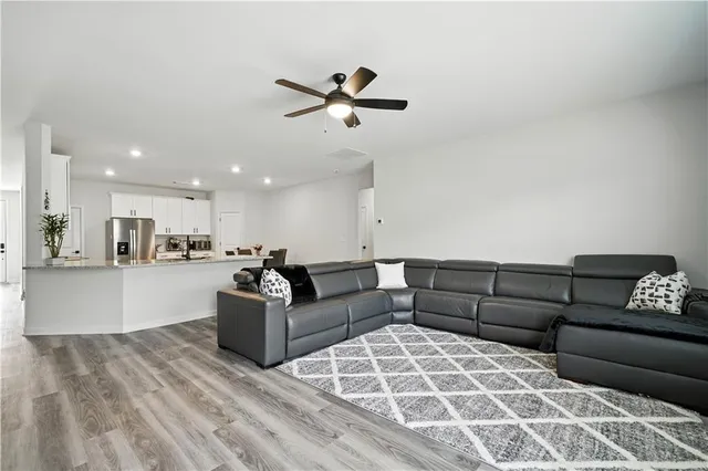 a living room with furniture and kitchen view