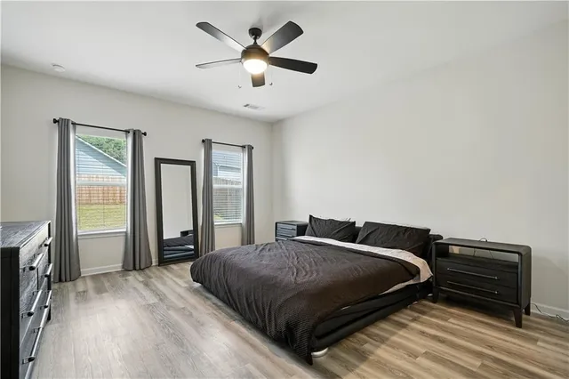 a bedroom with a large bed and a tv