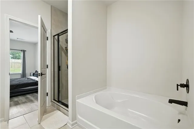 a bathroom with a tub and shower