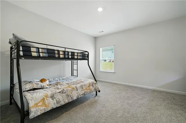 a bed room with a bed and a window