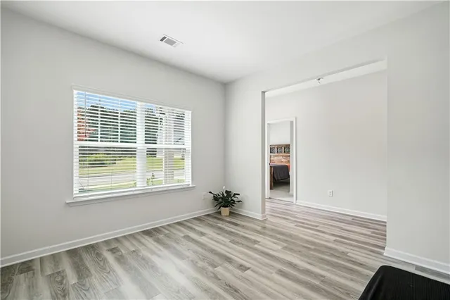 a view of a room with wooden floor and a window
