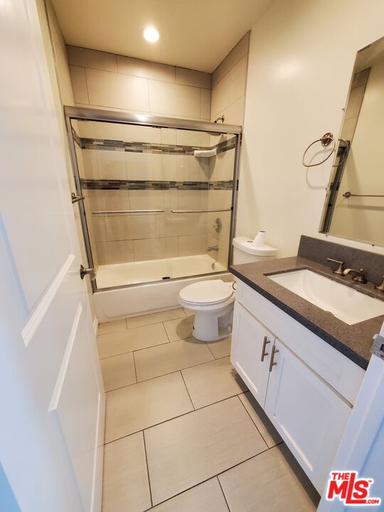 2227 Hauser Boulevard Los Angeles, CA 90016 - Photo 21 of 27 a bathroom with a granite countertop sink toilet and shower