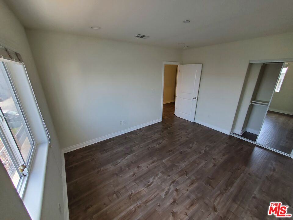 2227 Hauser Boulevard Los Angeles, CA 90016 - Photo 24 of 27 an empty room with wooden floor and windows
