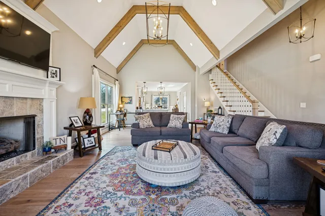 a living room with furniture and a chandelier