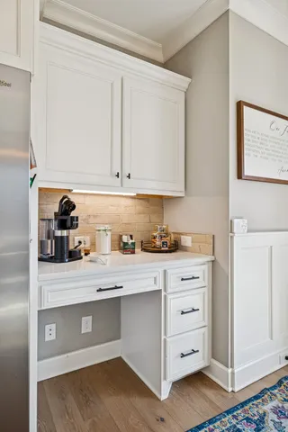 a en suite bathroom with a granite countertop sink and a mirror